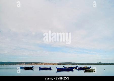 Il paese di Sant'Antioco e le barche dei pescatori viste dallo stagno di Santa Caterina, Sant'Antioco, Isola, Sardegna, Italia Foto Stock