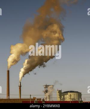 Fumo scuro proveniente dai camini di una vecchia fabbrica Foto Stock