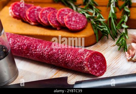 Salsiccia secca sul tagliere. Tradizionale prodotto spagnolo a base di carne Foto Stock