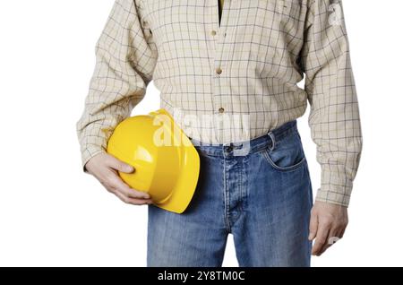 Contractor caucasico di media età sweared in jeans blu e camicia tiene il cappello giallo in mano su sfondo bianco Foto Stock