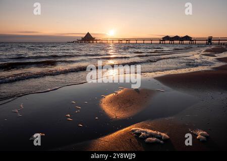 Wunderschöner Sonnenaufgang am Ostseestrand auf Usedom im Seebad Heringsdorf, einem der 3 sogenannten Kaiserbäder. Im Hintergrund die markante Seebrücke von Heringsdorf. Strand *** splendida alba sulla spiaggia del Mar Baltico di Usedom nella località balneare di Heringsdorf, una delle 3 cosiddette terme imperiali sullo sfondo, il suggestivo molo della spiaggia di Heringsdorf Foto Stock