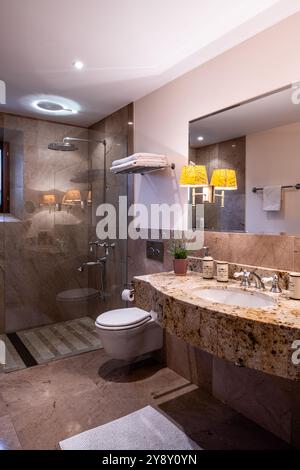Specchio sopra il lavandino in marmo con WC e doccia nella villa spagnola di Maiorca. Foto Stock