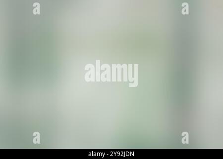 Un'immagine astratta e sfocata che mostra uno sfondo verde con alcune linee e forme deboli che si fondono sottilmente l'una nell'altra Foto Stock