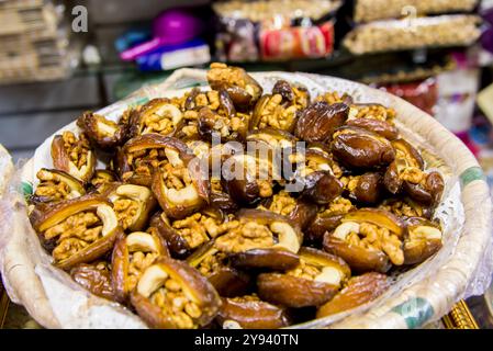 Datteri ripieni di noci nei negozi lungo le strette strade acciottolate della Kasbah a Bab al Fahs, Medina vecchia, Tangeri, Marocco, Nord Africa, Africa Foto Stock