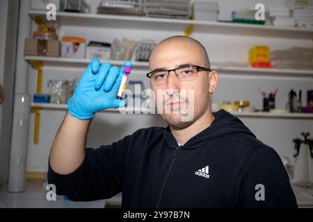 Belgrade, Serbia, Sep 21, 2024: A scientist processes blood samples in a biochemical laboratory. Stock Photo