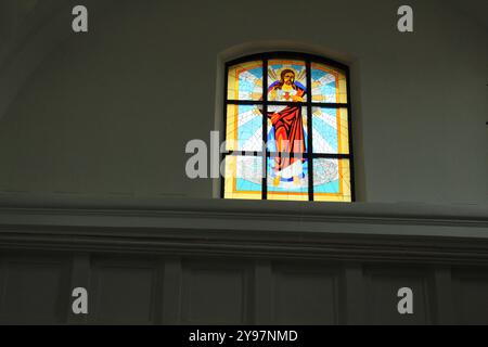 Vetrate colorate sulla finestra su sfondo grigio con spazio per testo di spazio. Vetrate colorate nella chiesa, nel tempio, nella chiesa cattolica. Foto Stock