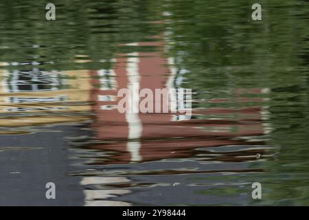 Edifici colorati che si riflettono in uno stagno creano un effetto misto. Foto Stock