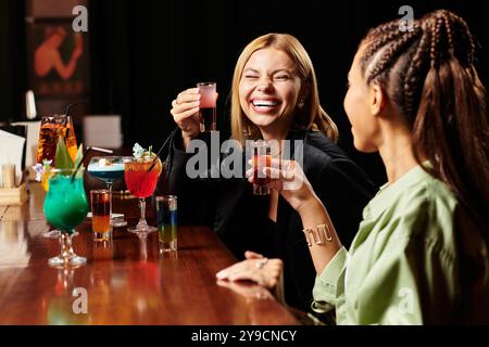 I colleghi si godono una vivace serata di drink e risate in occasione di una festa aziendale insieme. Foto Stock