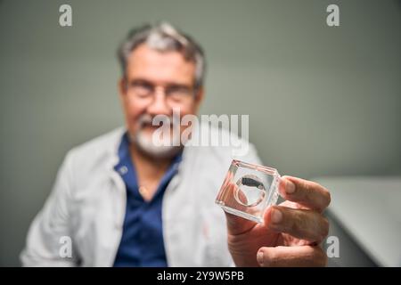 Primo piano di un medico caucasico con l'apparecchio acustico Foto Stock