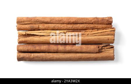 Bastoncini di cannella Ceylon, dall'alto. Tre strisce di corteccia secca del vero albero di cannella, Cinnamomum verum, disposte parallelamente l'una all'altra. Foto Stock