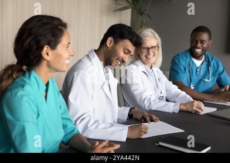Felice giovane uomo medico firma contratto di lavoro con ospedale moderno Foto Stock