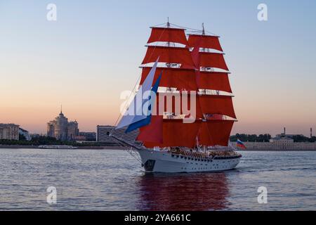 ST. PIETROBURGO, RUSSIA - 27 GIUGNO 2024: Brig "Russia" nelle acque della Neva al crepuscolo di giugno. Prova della vacanza dei laureati Scarlet Sails Foto Stock