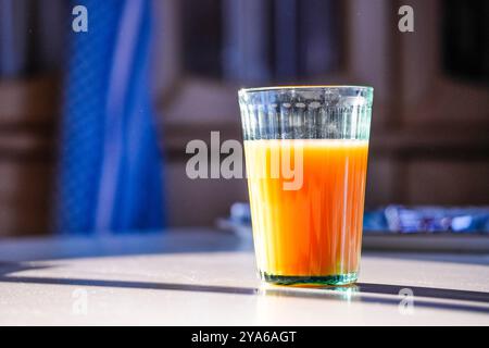 Succo di frutta al tavolo della colazione alla luce del sole Foto Stock