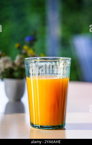 Succo di frutta al tavolo della colazione alla luce del sole Foto Stock