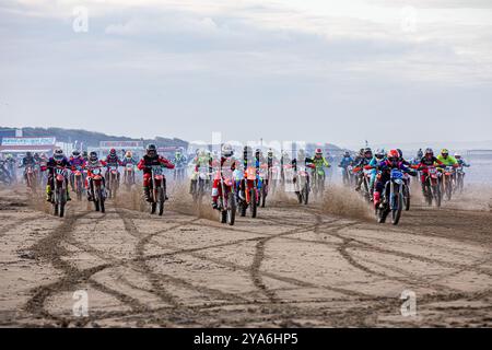 Weston-super-Mare, Somerset, Inghilterra, Regno Unito. 12 ottobre 2024, i piloti che lasciano il cancello di partenza nella classe 125cc/250cc il giorno 1 della ROKIT Weston Beach Race 2024. Quest'anno ricorre il 41° anniversario della prestigiosa Weston Beach Race e promette di essere un evento spettacolare che celebra oltre quattro decenni di eccellenza fuoristrada. Accreditamento John Rose/Alamy Live News Foto Stock