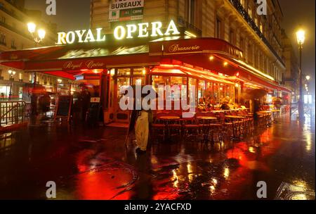 La tradizionale caffetteria francese brasserie Royal Opera con clienti non identificati di notte. Si trova vicino al Teatro dell'Opera Nazionale di Parigi, in Francia. Foto Stock