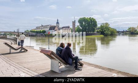 Chalon-sur-Saone, Francia - 30 aprile 2024: Viale lungo il fiume Saone con vista sull'isola di Saint-Laurent e il nostro du Doyenne a Chalon-sur-Saone, nella regione francese della Borgogna Foto Stock