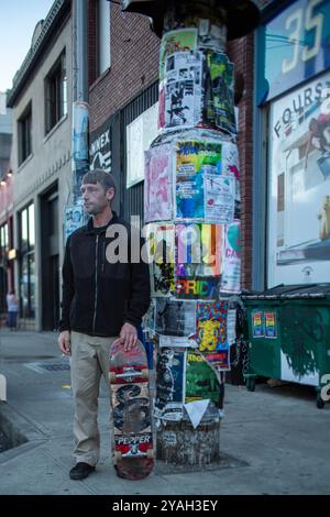 Skateboarder che fuma in un angolo di strada a Seattle Foto Stock