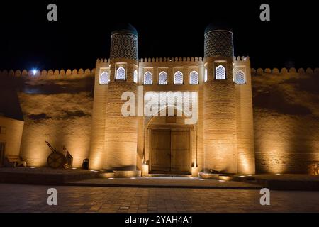 Vista notturna sulle enormi porte della fortezza interna Kunya-Ark della città vecchia di Khiva, Ichan Kala, Uzbekistan Foto Stock