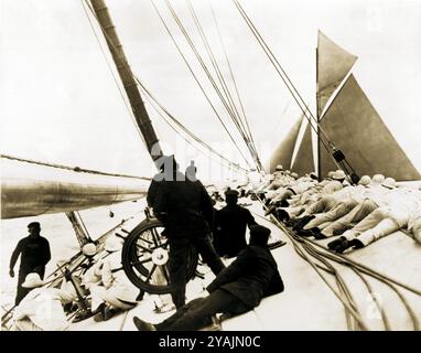 1903 IMMAGINI DEL PASSATO - gestito da PPL PHOTO AGENCY - Copyright Reserved1903 America's Cup: Il capitano Charlie Barr al volante del ya americano Foto Stock