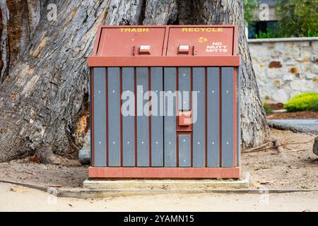 Un cestino a doppio scomparto a prova di animali e un cestino per il riciclaggio con sezioni etichettate. Nessun segno Mutt Mitts Foto Stock