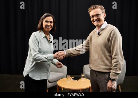 Una giornalista intervista calorosamente una donna specializzata nel suo campo, favorendo un dialogo approfondito. Foto Stock