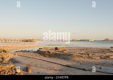 La spiaggia ha danneggiato l'onda della tempesta dopo gli uragani Helene e Milton a Gulfport Beach in Florida. Solchi, calanchi, canali d'acqua e detriti nella sabbia in ritardo Foto Stock