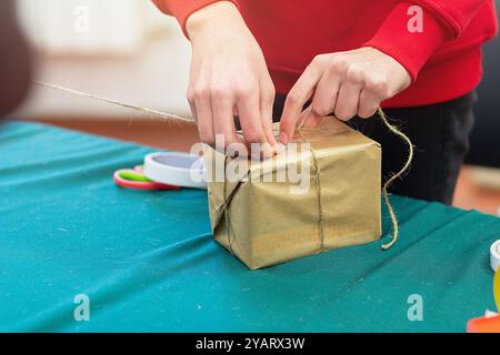 Uomo che confeziona un regalo in carta in stile retrò Foto Stock