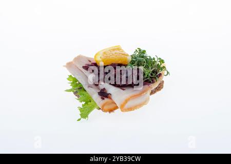 Salato smørrebrød danese con insalata di carne, pâté e bacon su rugbrød. Un classico sandwich a vista, perfetto per un pasto abbondante. Foto Stock