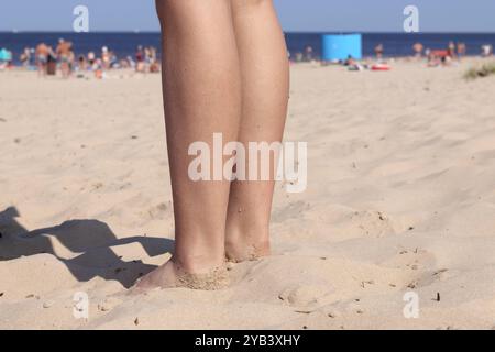 impronte nella sabbia della spiaggia sullo sfondo del mare blu Foto Stock