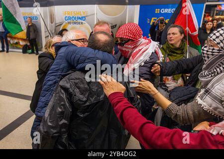 Leeds, Regno Unito. 16 OTTOBRE 2024. Un uomo è dirompente e presumibilmente assalto a favore del protestatore palestinese, portando a parlare con entrambi gli uomini dalla polizia, non ci sono stati arresti. Questo avviene quando i manifestanti palestinesi hanno organizzato una dimostrazione all'interno della stazione degli autobus di Leeds in seguito alla protesta fuori dagli uffici della BBC Yorkshire nel centro di Leeds accusandoli di pregiudizi nella copertura del conflitto di Gaza. Credito Milo Chandler/Alamy Live News Foto Stock