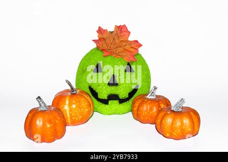 Buon halloween, Jack o lanterna con una foglia sulla parte superiore e quattro zucche arancioni decorative su sfondo bianco Foto Stock