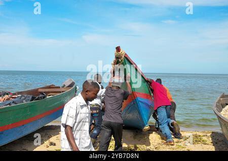 Pescatori che spingono una barca nel lago Victoria a Kasensero, città di pescatori, in Uganda Foto Stock