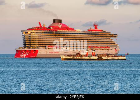 Waverley, l'unico piroscafo a pale al mondo, passa davanti alla nave da crociera Virgin Voyages Resilient Lady, nel Solent. Foto Stock