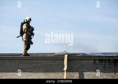 Vigile del fuoco che fa fuoco in una casa in Danimarca Foto Stock