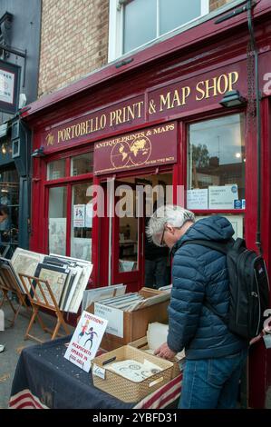 Gli amanti della stampa vecchia guardano una collezione presso il negozio Portobello Print & Map in Portobello Road. Londra Foto Stock