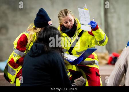 Jena, Germania. 20 ottobre 2024. Nello scenario "triage", i servizi di emergenza classificano le vittime in base alla loro priorità di trattamento. Esercitazione su larga scala nel tunnel Jagdberg sulla A4 tra gli svincoli "Bucha" e "Jena-Göschwitz" nella notte del 19/20 ottobre 2024. Nell'esercitazione sono coinvolti circa 200 servizi di emergenza dei vigili del fuoco, del controllo dei disastri e della polizia della superstrada. Crediti: Jacob Schröter/dpa/Alamy Live News Foto Stock