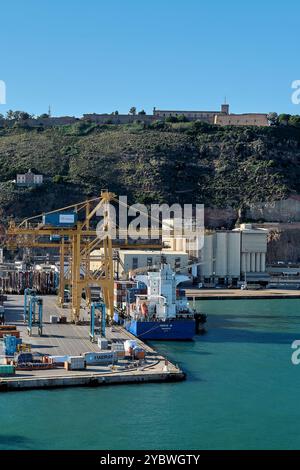 Barcellona. Espain -20 ottobre 2024: Porto di Barcellona in pieno svolgimento, con una nave da carico e gru in movimento per caricare e scaricare merci internazionali. Foto Stock