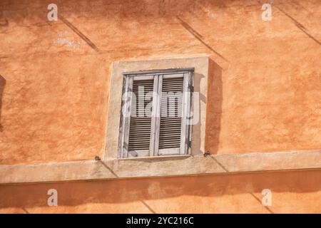 Vecchia finestra sul muro di un bellissimo edificio d'epoca a Roma, in Italia Foto Stock
