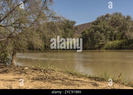 Paesaggio sulle rive del fiume Kunene, il fiume di confine tra Namibia e Angola Foto Stock