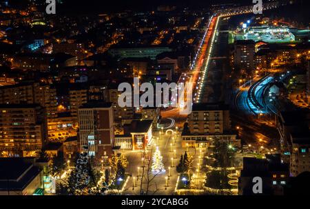 Una città piena di luci vista dalla cima della collina Foto Stock