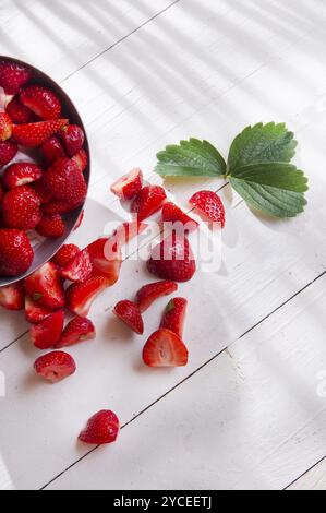 Piccoli pezzi di fragole per la preparazione dell'insalata Foto Stock