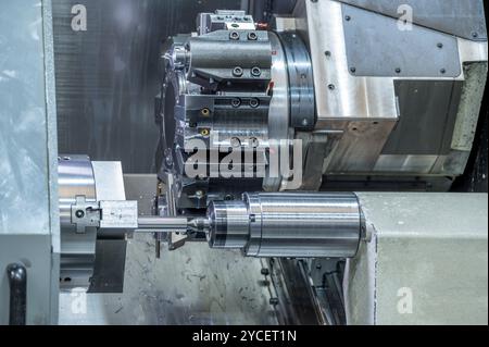 La macchina per tornio CNC che forma il taglio delle parti metalliche. Lavorazione dei metalli ad alta tecnologia mediante tornitura CNC, grafica Foto Stock