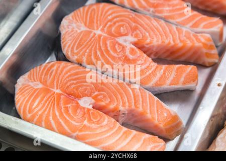 Bistecche di salmone crude su piastra metallica in vetrina Foto Stock