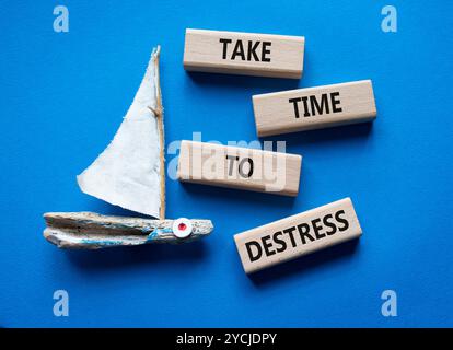 Prenditi del tempo per il simbolo di destress. I blocchi di legno con le parole richiedono tempo per destreggiarsi. Bellissimo sfondo blu con barca. Affari e tempo per destreggiarsi Foto Stock