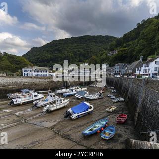 Lynton and Lynmouth, Regno Unito, 2 settembre 2022: Il porto e il villaggio di Lynmouth nel Devon settentrionale con molte barche bloccate con la bassa marea Foto Stock