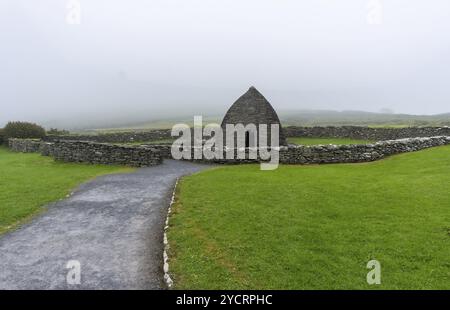 Una vista panoramica della chiesa paleocristiana Gallarus Oratory nella contea di Kerry in una mattina nebbia Foto Stock