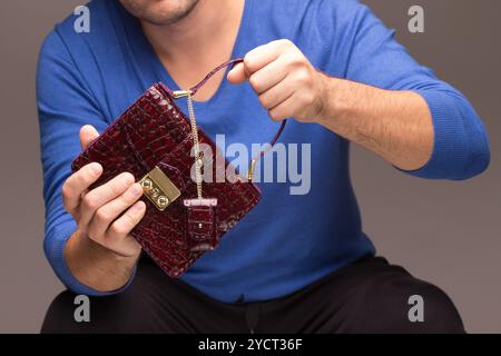Mani maschili forti che tengono le borse Foto Stock