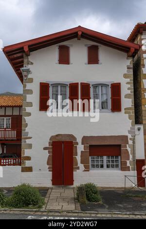 Ainhoa. Francia, 16 aprile 2024: Tipica casa basca colorata nel villaggio di montagna di Ainhoa nei Pirenei Foto Stock