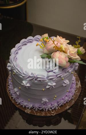 Una deliziosa torta viola con un fiore, semplice, gustosa e perfetta per qualsiasi evento! Questa torta regala ai tuoi festeggiamenti un tocco unico. Foto Stock